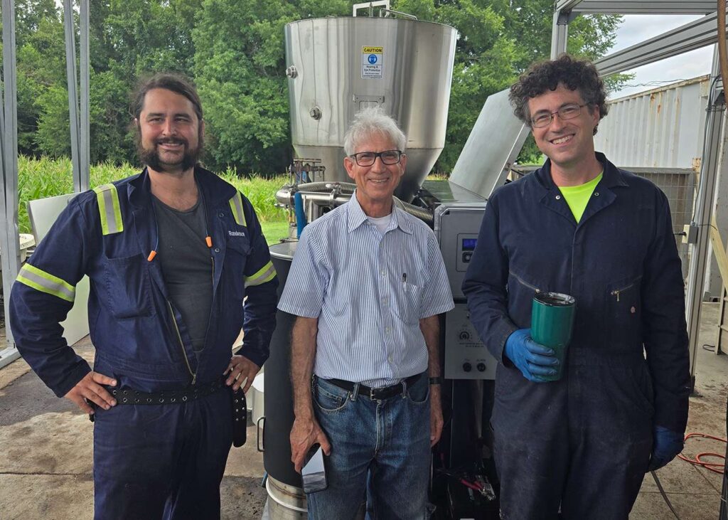 Three workers stand in front of APL PP30 at NCA&T